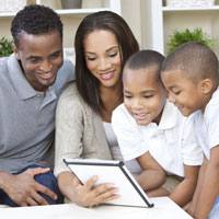 Father and son play next to a lake